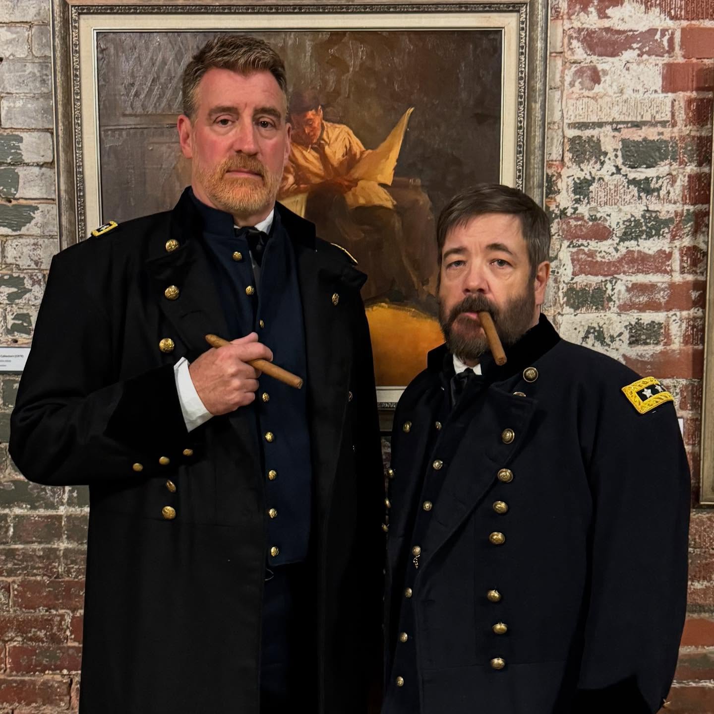 Grant and Sherman stand in front of a painting and brick wall at the American Philatelic Center in Bellefonte
