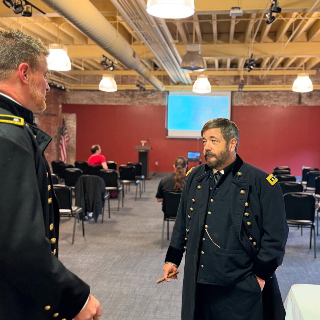 Dan Snyder as General Sherman conversing with Derek Maxfield as General Grant in the lecture hall at the American Philatelic Center